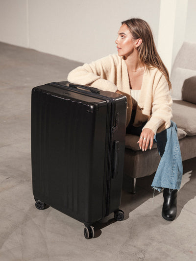 Studio product shot of front-facing CALPAK Ambeur large 30-inch black hardshell spinner luggage; LAM1028-BLACK view 2