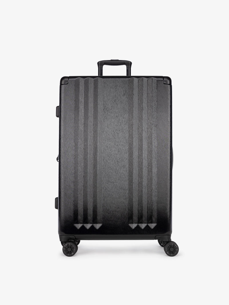 Studio product shot of front-facing CALPAK Ambeur large 30-inch black hardshell spinner luggage