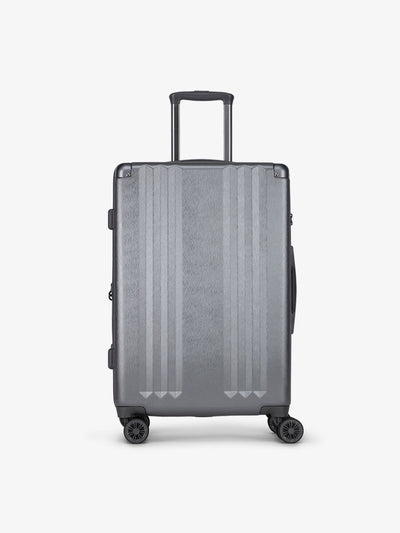 Studio product shot of front-facing CALPAK Ambeur medium 26-inch lightweight hardshell luggage with 360 spinner wheels in gunmetal; LAM1024-GUNMETAL view 1