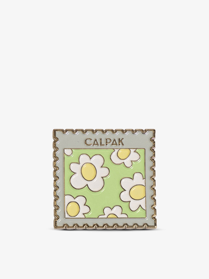 Front-view of CALPAK Stamp Enamel Pin with daisy print