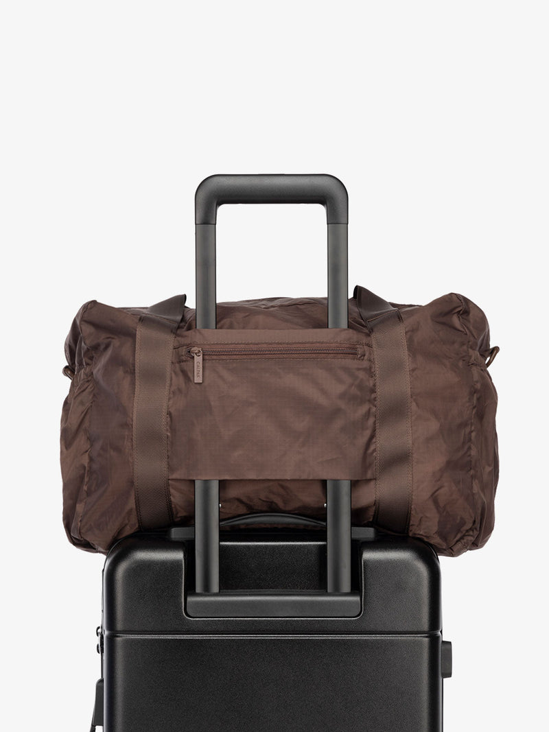 CALPAK Compakt nylon duffle bag with trolley sleeve in walnut brown