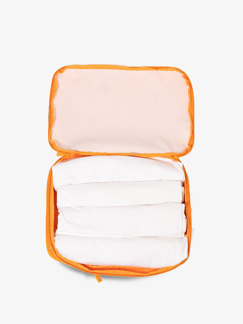 CALPAK packing cubes for travel in orange grid