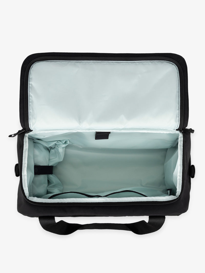 CALPAK Connect laptop duffel with multiple interior pockets and padded laptop sleeve with black exterior, blue interior