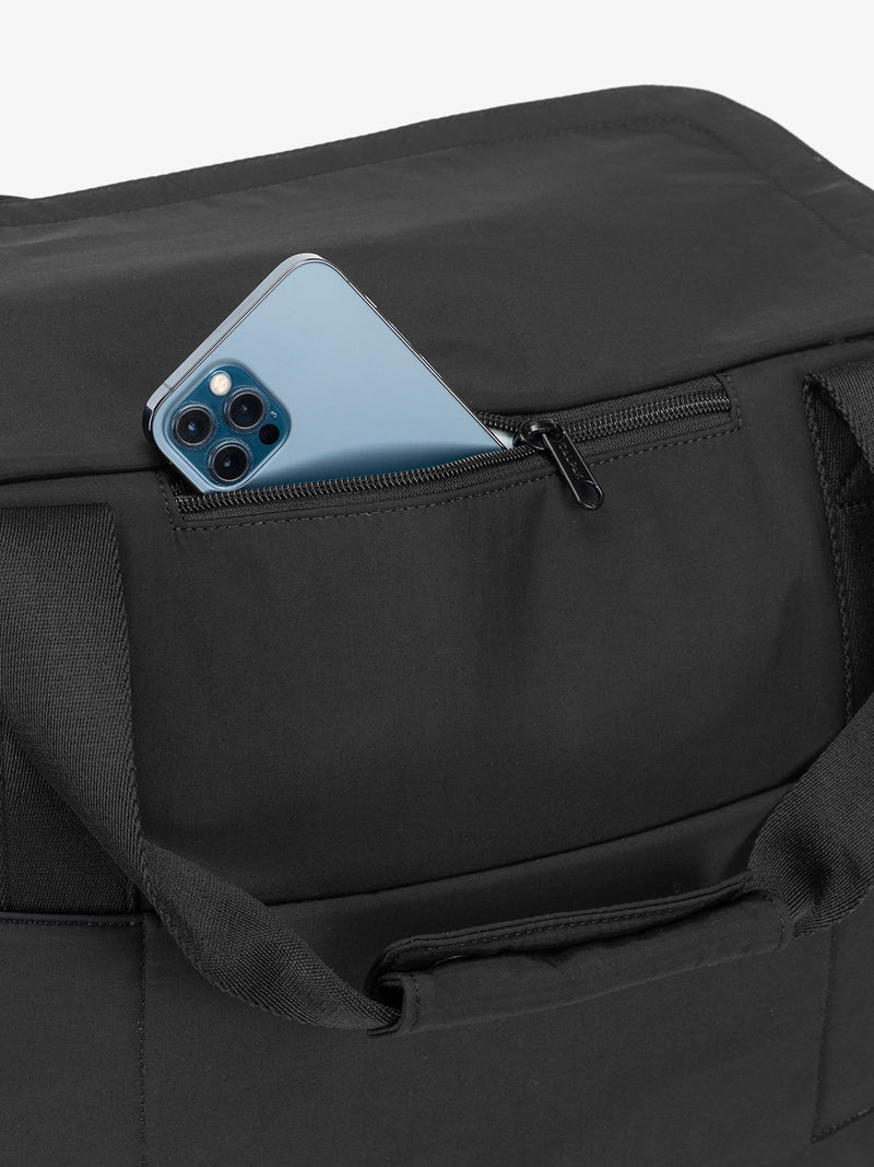 Zippered phone pocket of CALPAK Connect Laptop Duffel in black