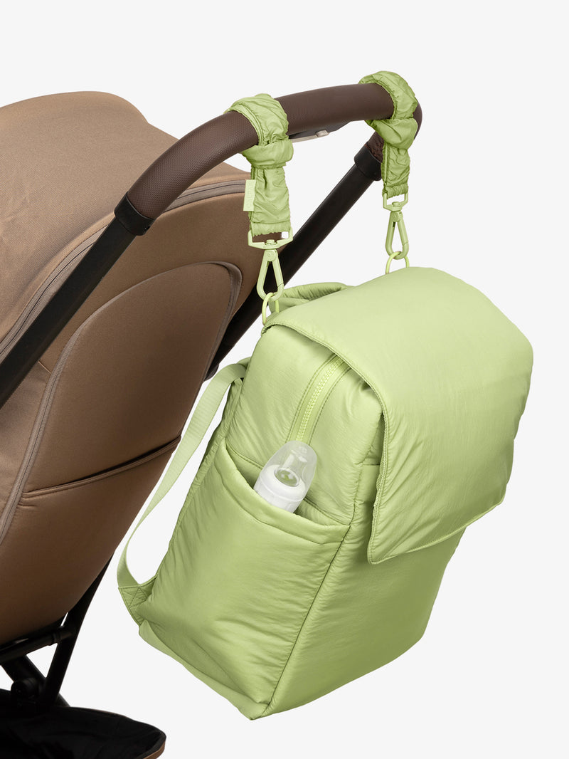 CALPAK Diaper Backpack in light green Lime with light green Lime Stroller Straps attached to a brown stroller