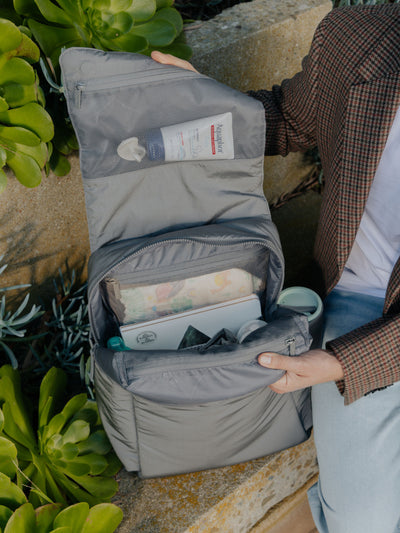 CALPAK Diaper Backpack with Laptop Sleeve attached to stroller by CALPAK Stroller Straps in slate; BPB2401-SLATE, BBPB2401-SLATE