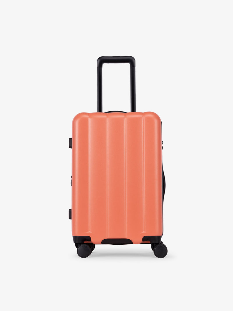 CALPAK Pacific blue carry-on luggage made from an ultra-durable polycarbonate shell and expandable by up to 2" in persimmon