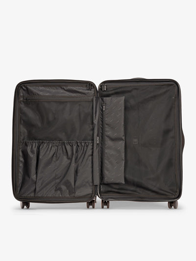 Raspberry CALPAK Evry Large Luggage features divided compartments with interior pockets for organized packing