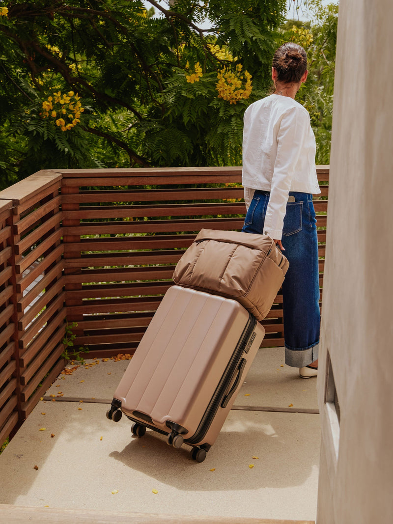 Model rolling CALPAK Evry Medium Luggage with CALPAK Luka Duffel in chocolate