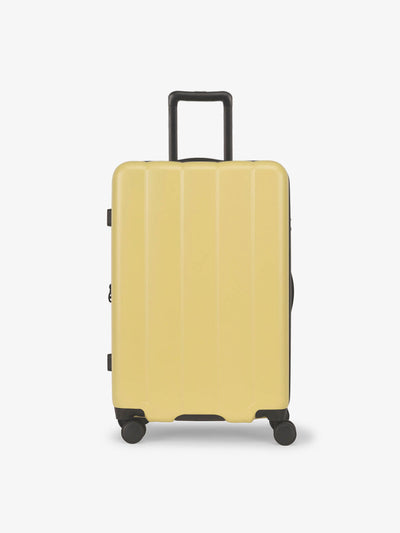 CALPAK Butter medium luggage made from an ultra-durable polycarbonate shell and expandable by up to 2; LCO1024-BUTTER view 1