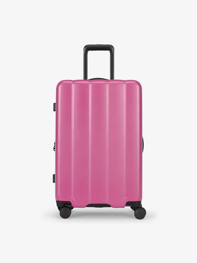 CALPAK raspberry medium luggage made from an ultra-durable polycarbonate shell and expandable by up to 2"