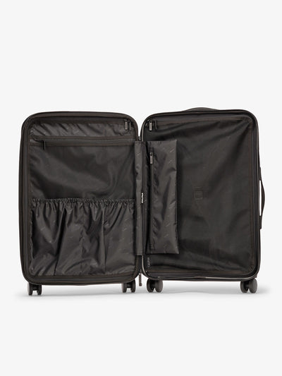 CALPAK Evry Medium Luggage features divided compartments with interior pockets for organized packing in raspberry