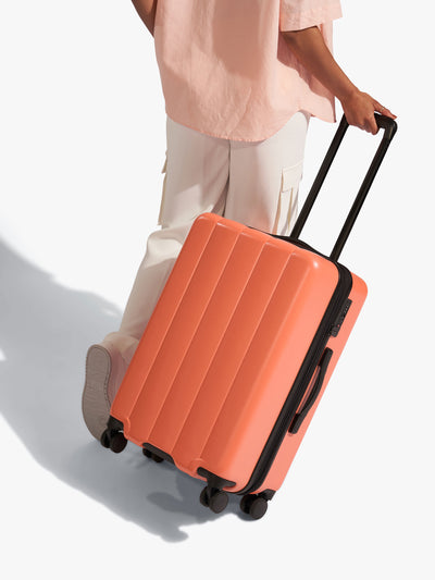 CALPAK Persimmon medium luggage made from an ultra-durable polycarbonate shell and expandable by up to 2