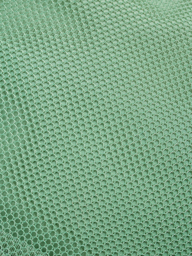 Close up of CALPAK Fit Hanging Dopp Kit's mesh interior pocket in sage green