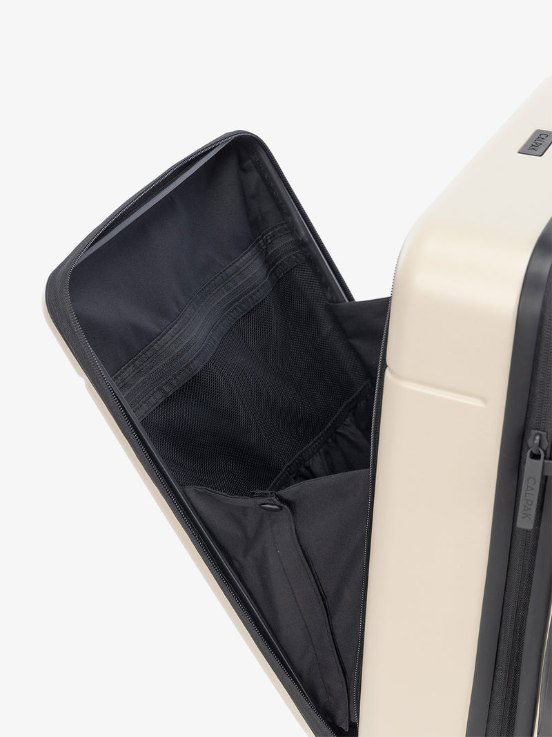 laptop compartment of CALPAK Hue carry-on suitcase in cream linen color