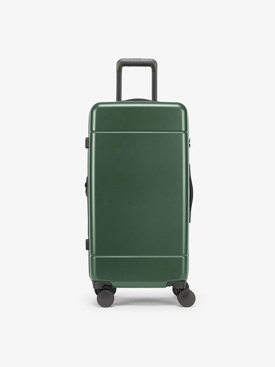 CALPAK Hue Medium Trunk Luggage with durable hard-shell exterior, cushioned top handle and 360 spinner wheels in emerald; LHU1026-EMERALD