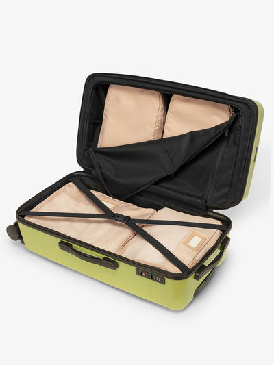 CALPAK Hue medium trunk suitcase with spacious interior and zippered divider with pockets in green key lime