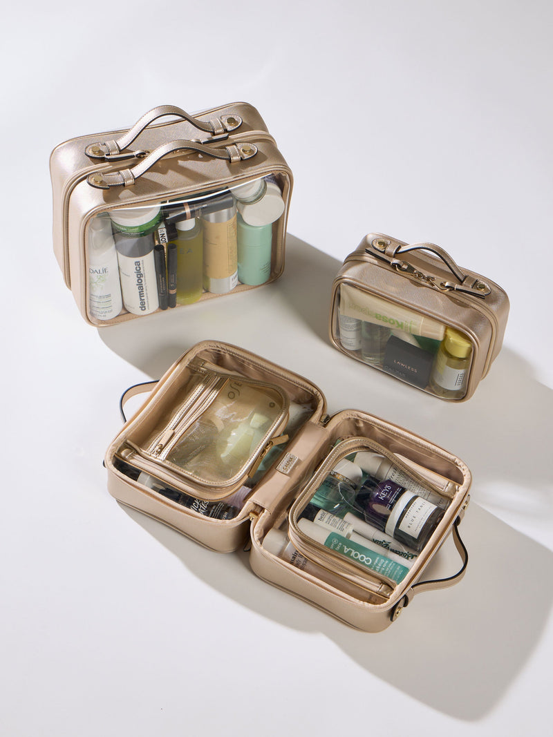 CALPAK Large Clear Cosmetic Case, Medium Clear Cosmetic Case, and Small Clear Cosmetic Case in gold