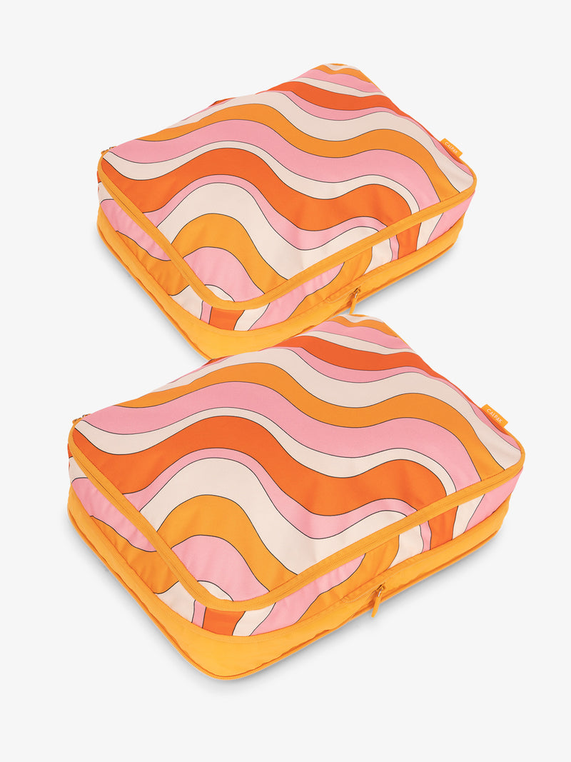 CALPAK large packing cubes with top handles and expandable by 4.5 inches in pink and orange retro sunset