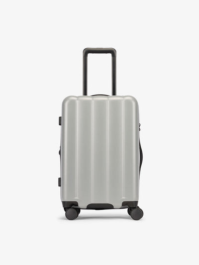 CALPAK Smoke gray carry-on luggage made from an ultra-durable polycarbonate shell and expandable by up to 2