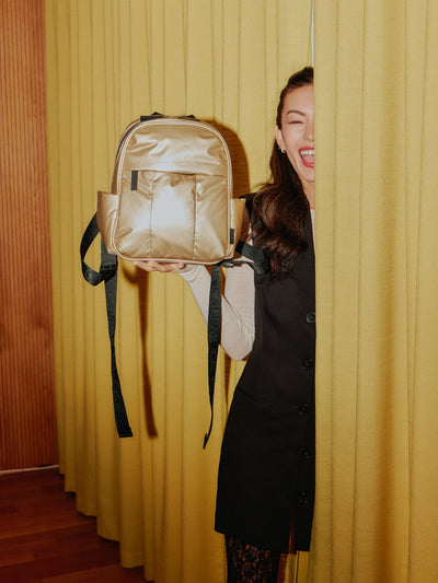 CALPAK Luka Mini Backpack with soft puffy exterior and front zippered pocket in metallic gold; BPM2201-GOLD view 2