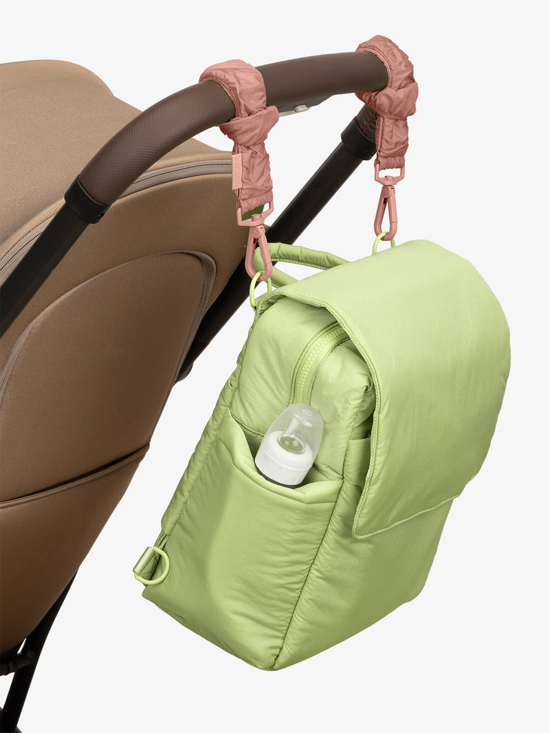 CALPAK Convertible Mini Diaper Backpack in light green Lime with pink Peony Stroller Straps attached to a brown stroller