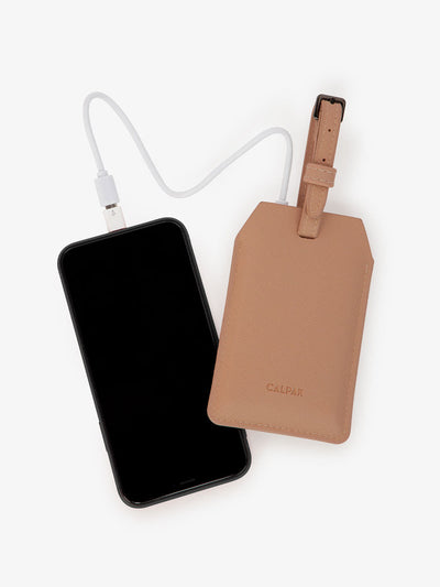 CALPAK Portable Luggage Tag + Charger with USB-C and Lightning adaptor compatibility in caramel; APT2401-CARAMEL view 1