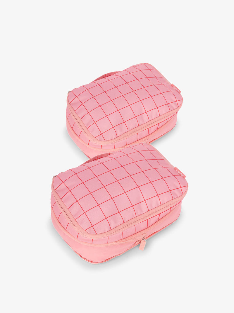 CALPAK small compression packing cubes with top handles and expandable by 4.5 inches in pink and red grid print