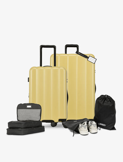 CALPAK starter bundle with carry-on, large luggage, packing cubes, pouches, and luggage tag in butter; LCO8000-BUTTER view 1