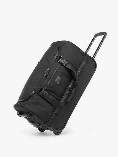 CALPAK Stevyn Rolling Duffel side view in black; DSR2201-BLACK view 1