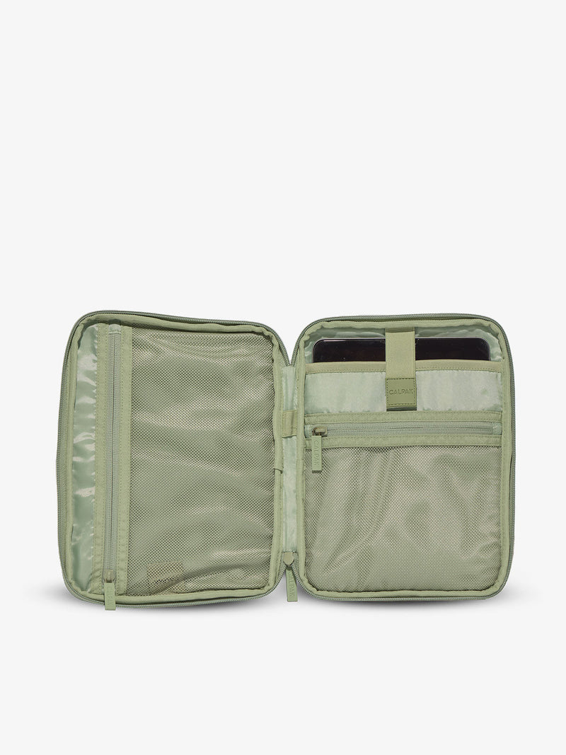 Interior of CALPAK tablet organizer with zippered pockets and padded tablet sleeve in green daisy