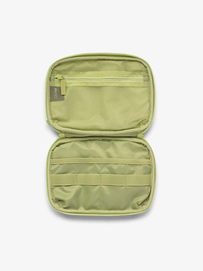 Interior view of CALPAK tech organizer in abstract green lime viper with loops and zippered pockets for organizing electronics and belongings