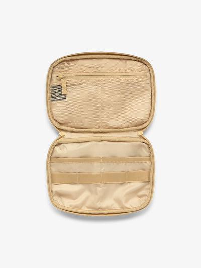 Interior view of CALPAK tech organizer in oatmeal beige with loops and zippered pockets for organizing electronics and belongings