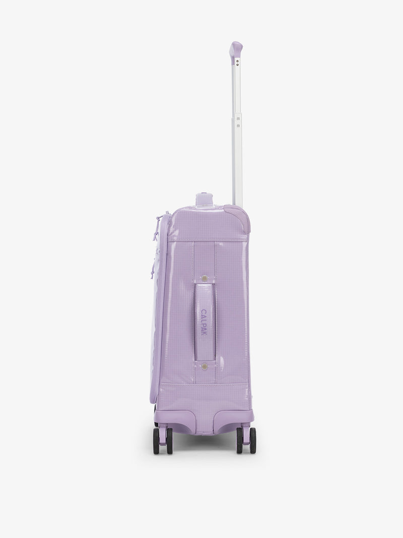 Studio product shot of side-facing CALPAK Terra 35L Carry-On luggage with soft shell and 360 spinner wheels in amethyst