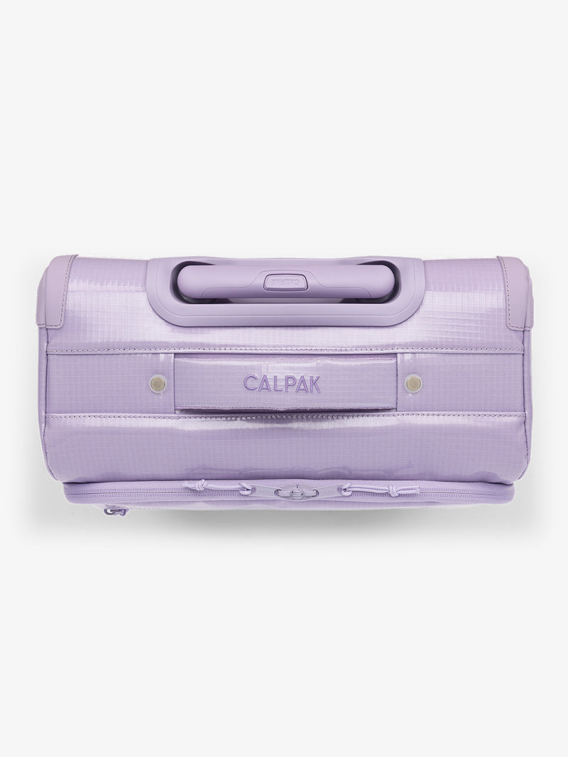 Studio product shot of top handle of CALPAK Terra 35L Carry-On luggage with soft shell and 360 spinner wheels in light purple