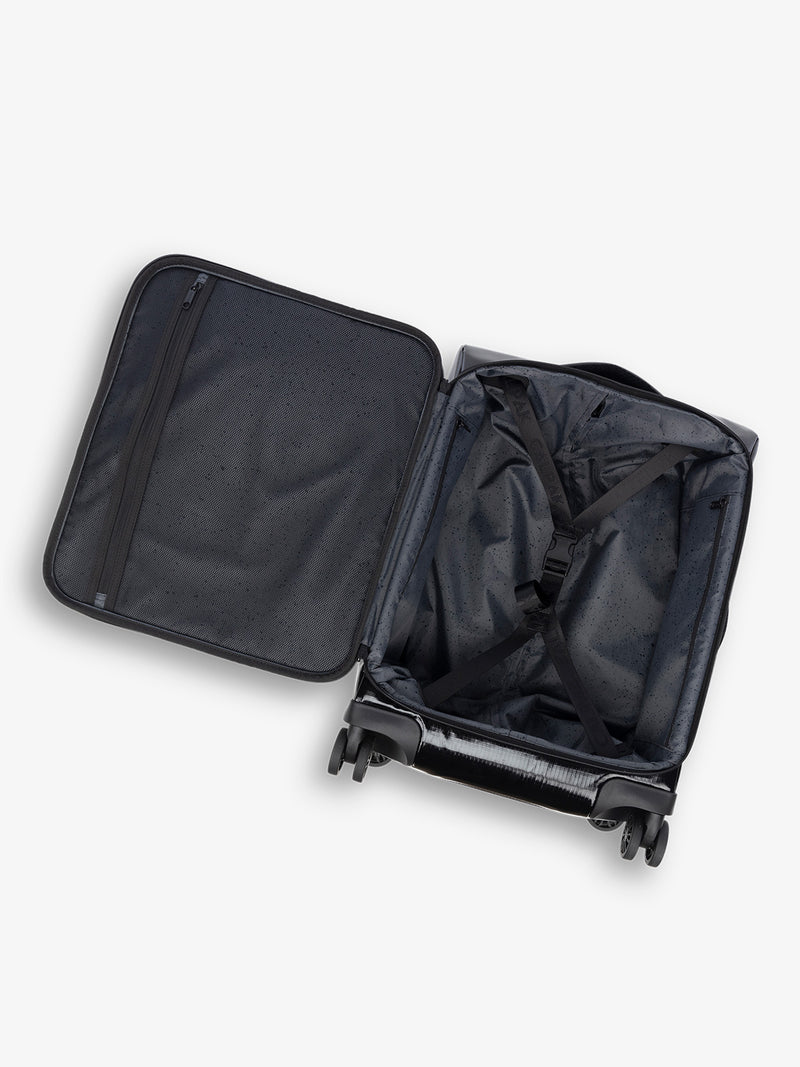 Studio product shot of interior compartment of CALPAK Terra 35L Carry-On luggage with soft shell and 360 spinner wheels in black obsidian