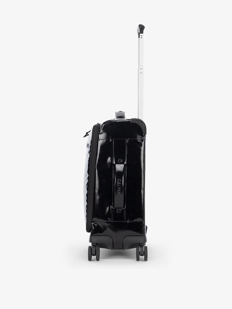 Studio product shot of side-facing CALPAK Terra 35L Carry-On luggage with soft shell and 360 spinner wheels in black