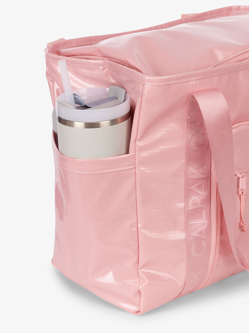 CALPAK Terra 35L Water Resistant Zippered Tote Bag with exterior side pocket that can fit large water bottle in pink