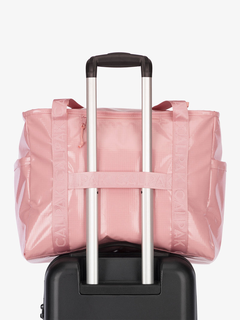 Luggage trolley sleeve of CALPAK Terra 35L Water Resistant Zippered Tote Bag in pink