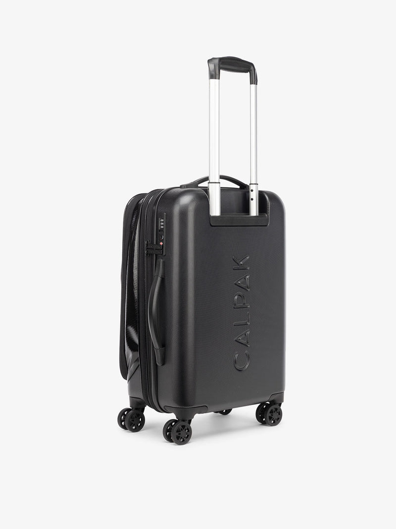 CALPAK Terra Carry-On Luggage hard shell back view with 360 spinner wheels and grab handles in obsidian