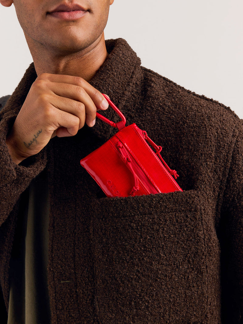 CALPAK Terra Clippable Card Pouch in red being put into pocket of model