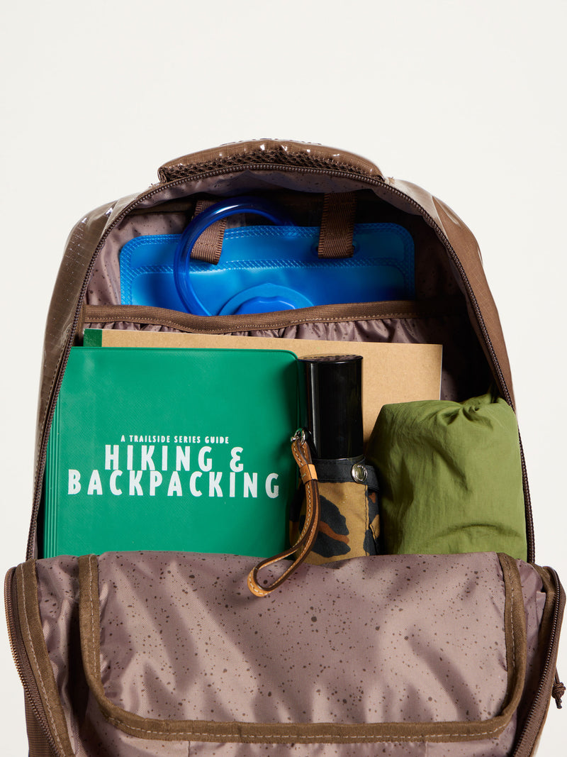 CALPAK Terra Hydration Backpack interior with items packed within and hydration reservoir in back slip pocket in cacao