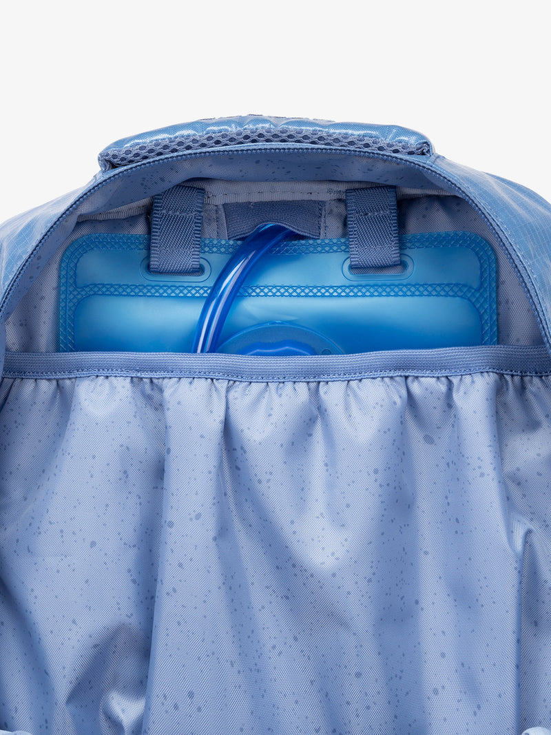 Close up of CALPAK 2L removable hydration reservoir back-slip pocket in blue