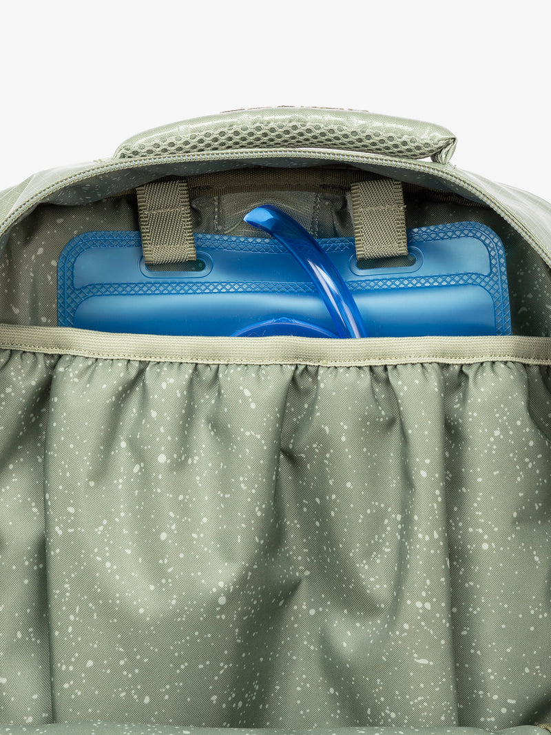 Close up of CALPAK 2L removable hydration reservoir pocket in green