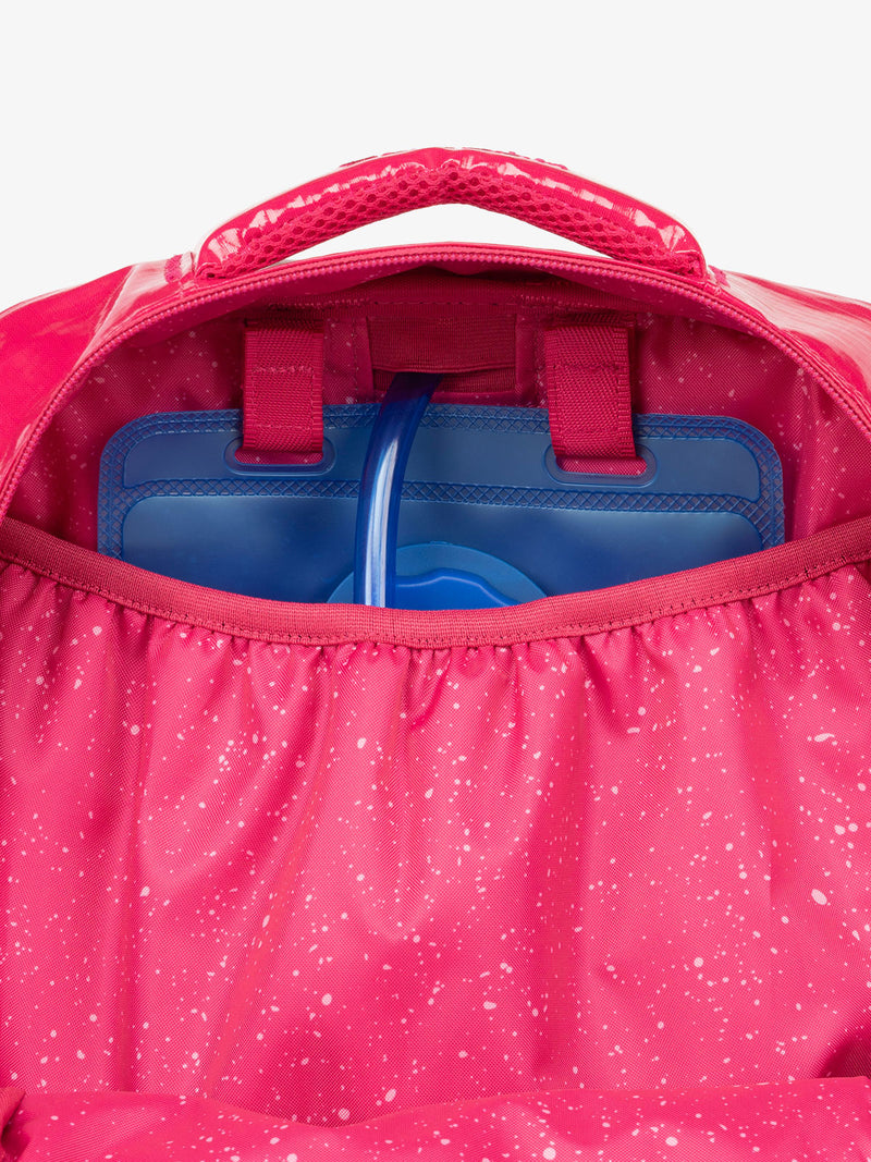 Close up of CALPAK 2L removable hydration reservoir back-slip pocket in pink dragonfruit