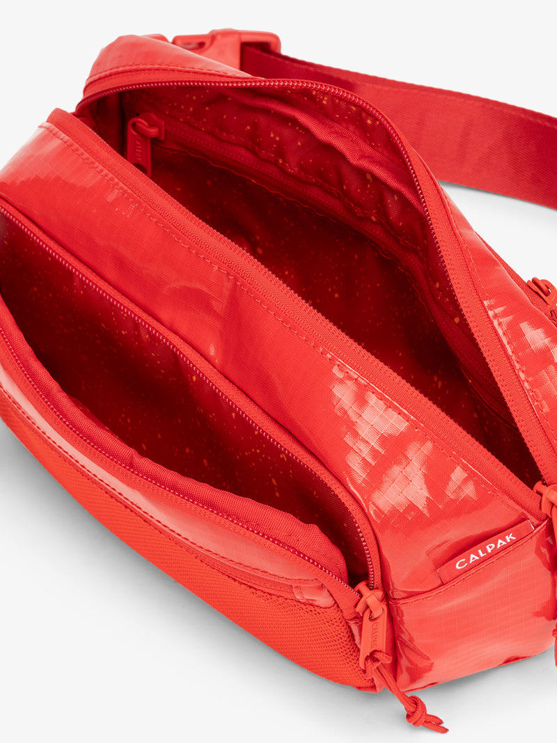 CALPAK Terra hiking belt bag with multiple interior pockets and water resistant exterior in flaming red