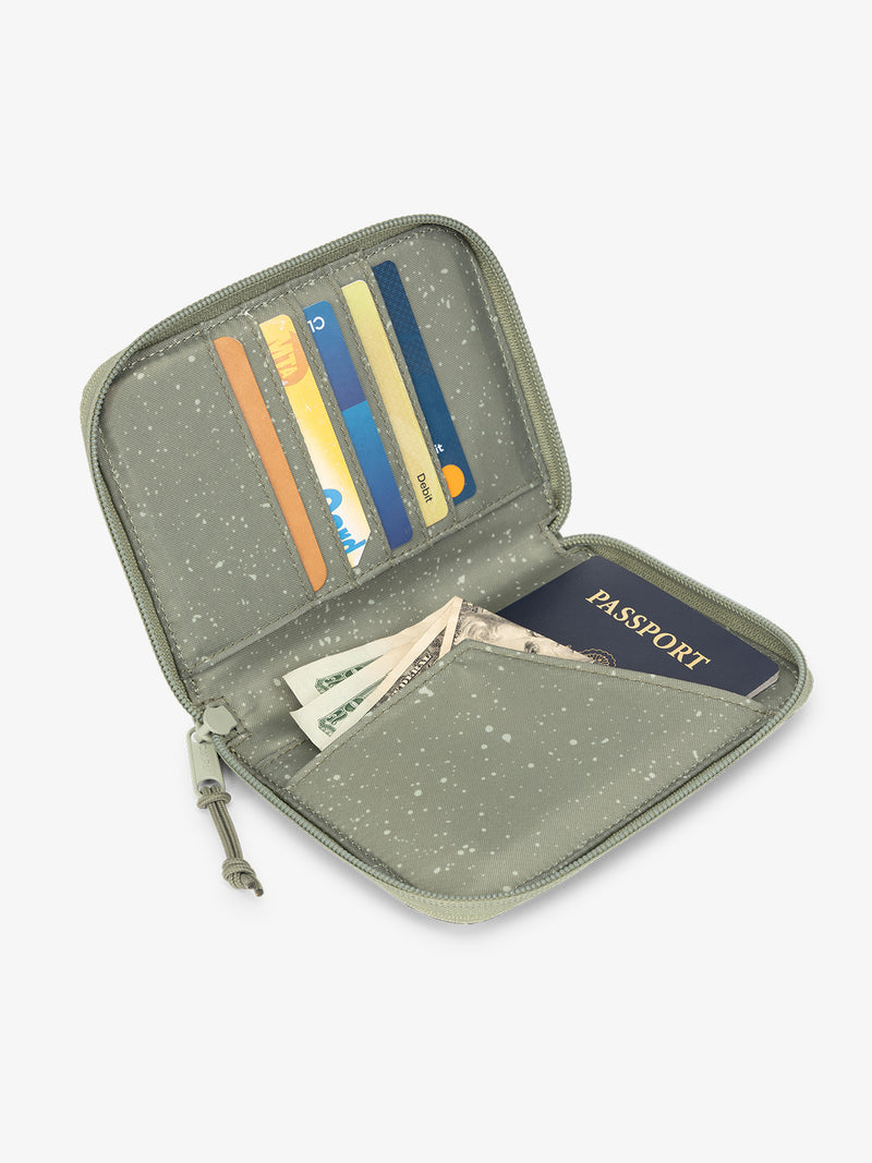 Green juniper CALPAK Terra Zippered Passport Wallet open view with cards in card slots and passport in passport slip