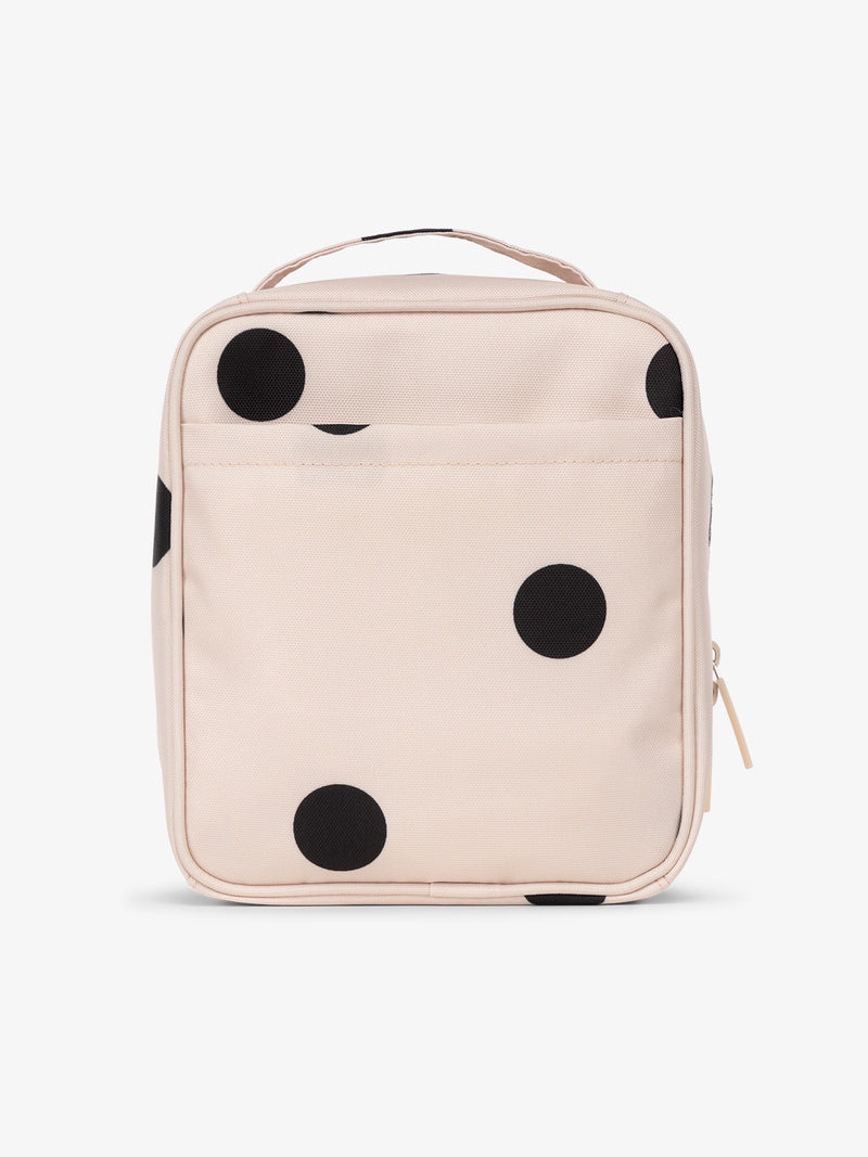 Backview of CALPAK The Everything Cube with exterior back slip pocket in  black and white polka dot print