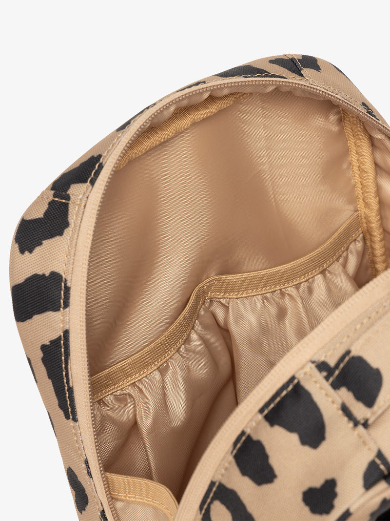 Interior view of CALPAK The Everything Cube featuring water resistant lining and interior pockets in cheetah print