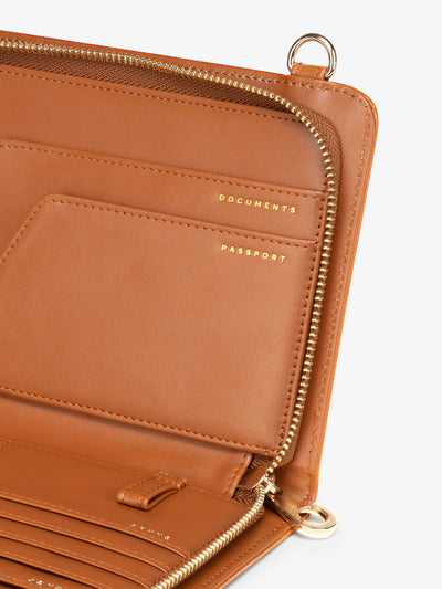 Close up of CALPAK faux croc travel wallet for documents and passport with RFID lining in cognac